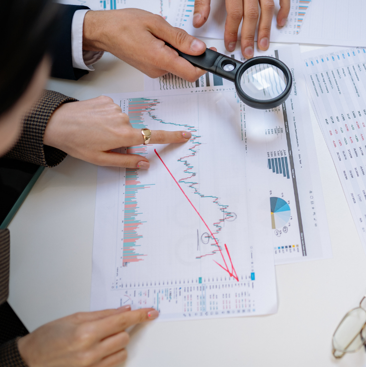 Two sets of hands reviewing business documents